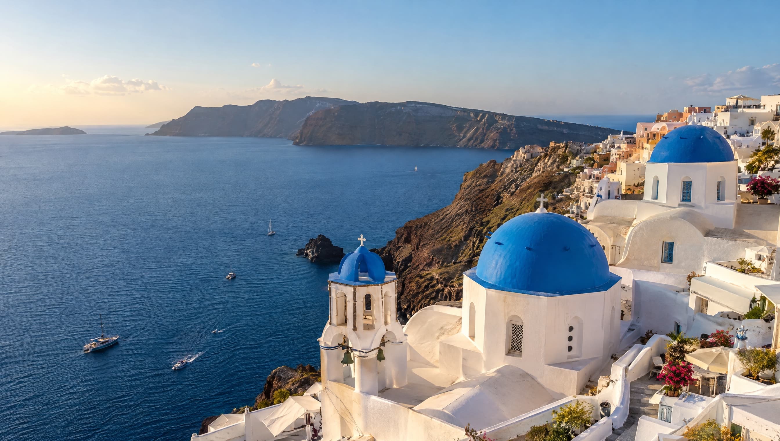 White buildings above the blue water in Santorini
